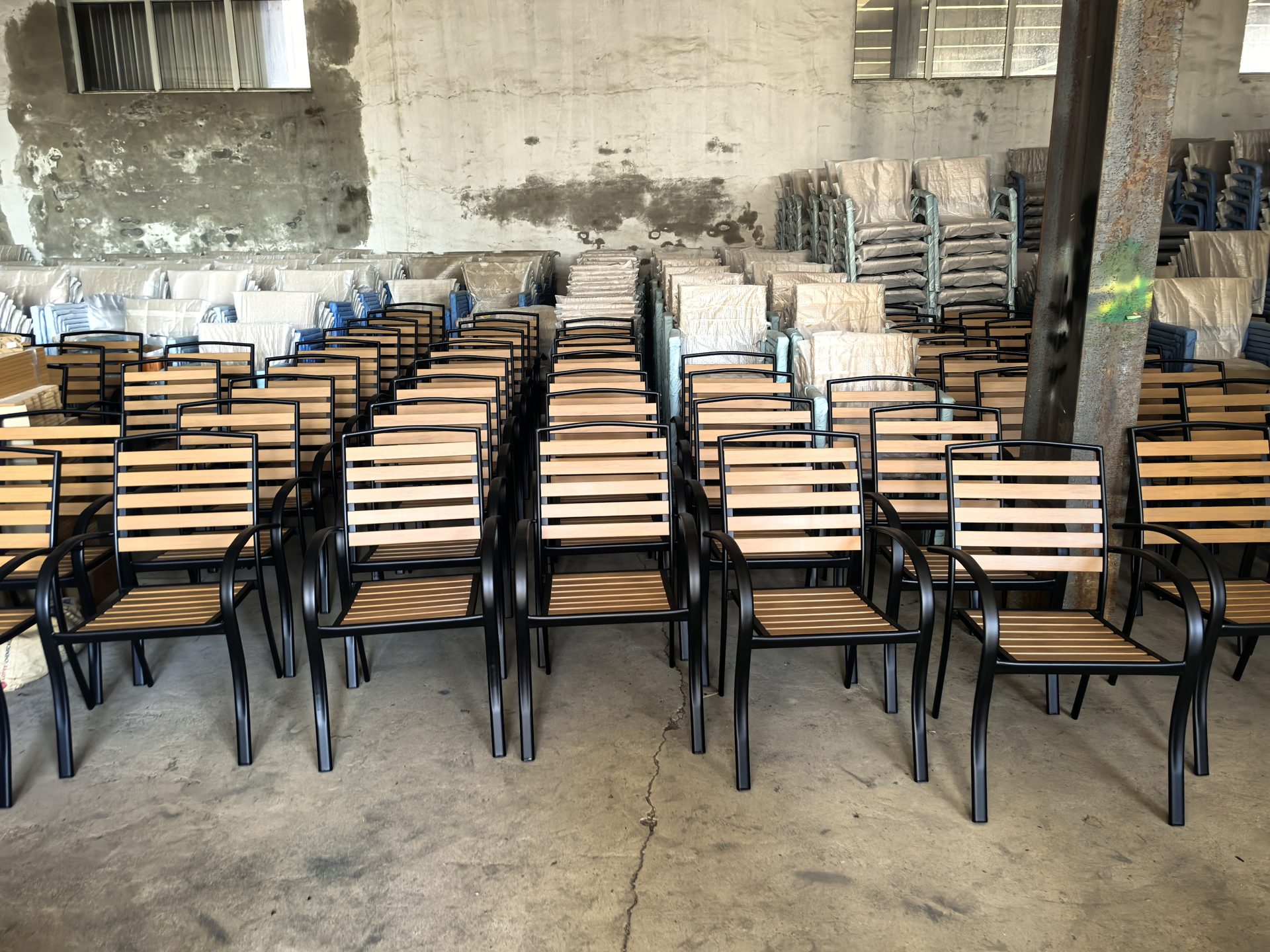 Finished goods warehouse stocked with completed rattan chairs