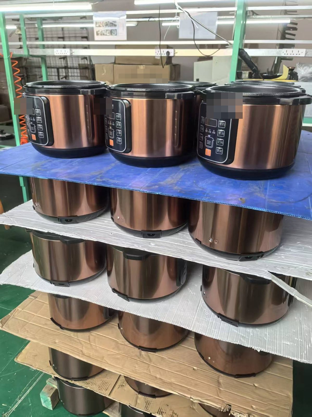 Finished rice cookers staged on racks inside a Chinese small-appliance factory