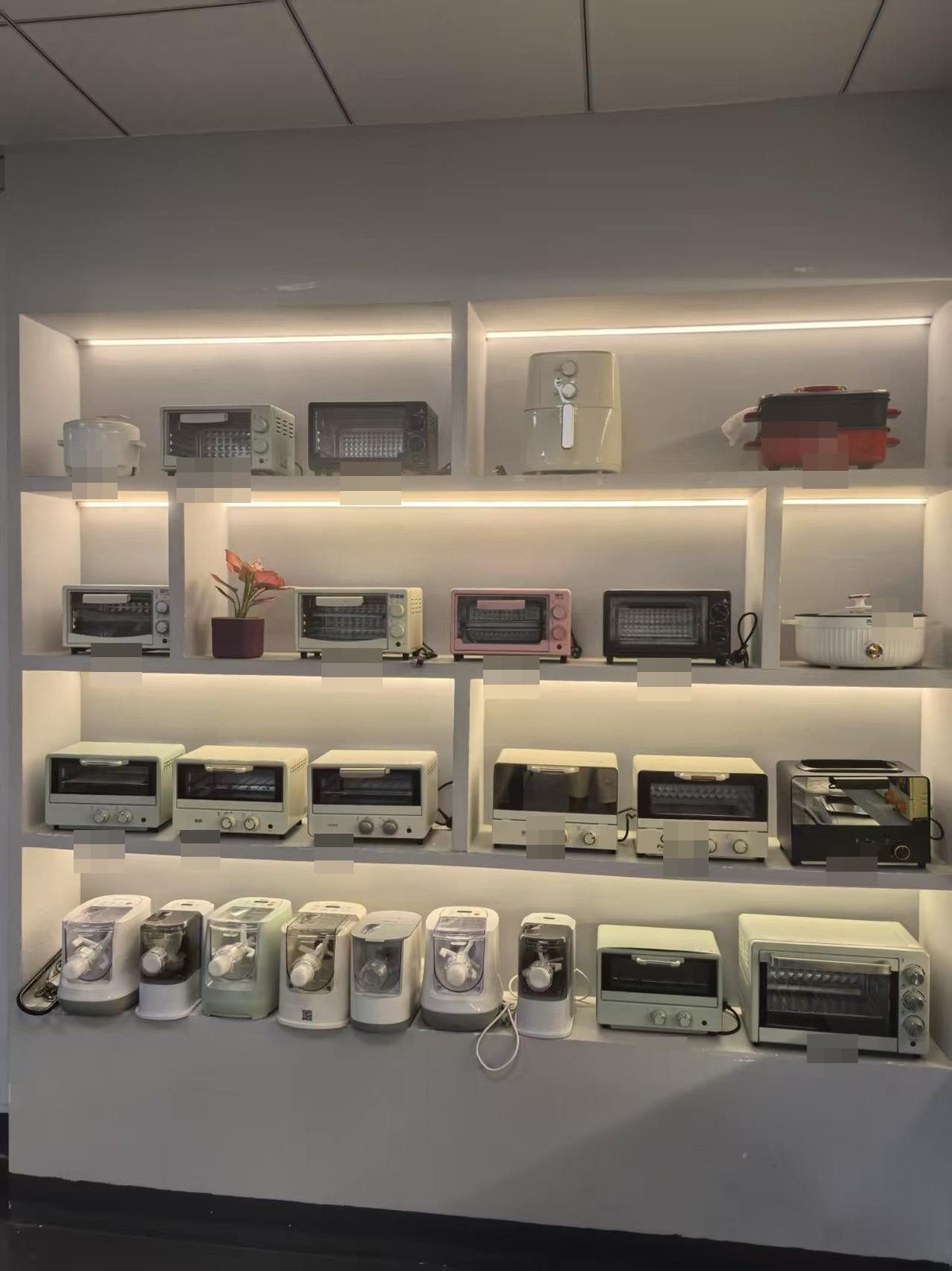 Wall of ovens and small appliances in a factory showroom