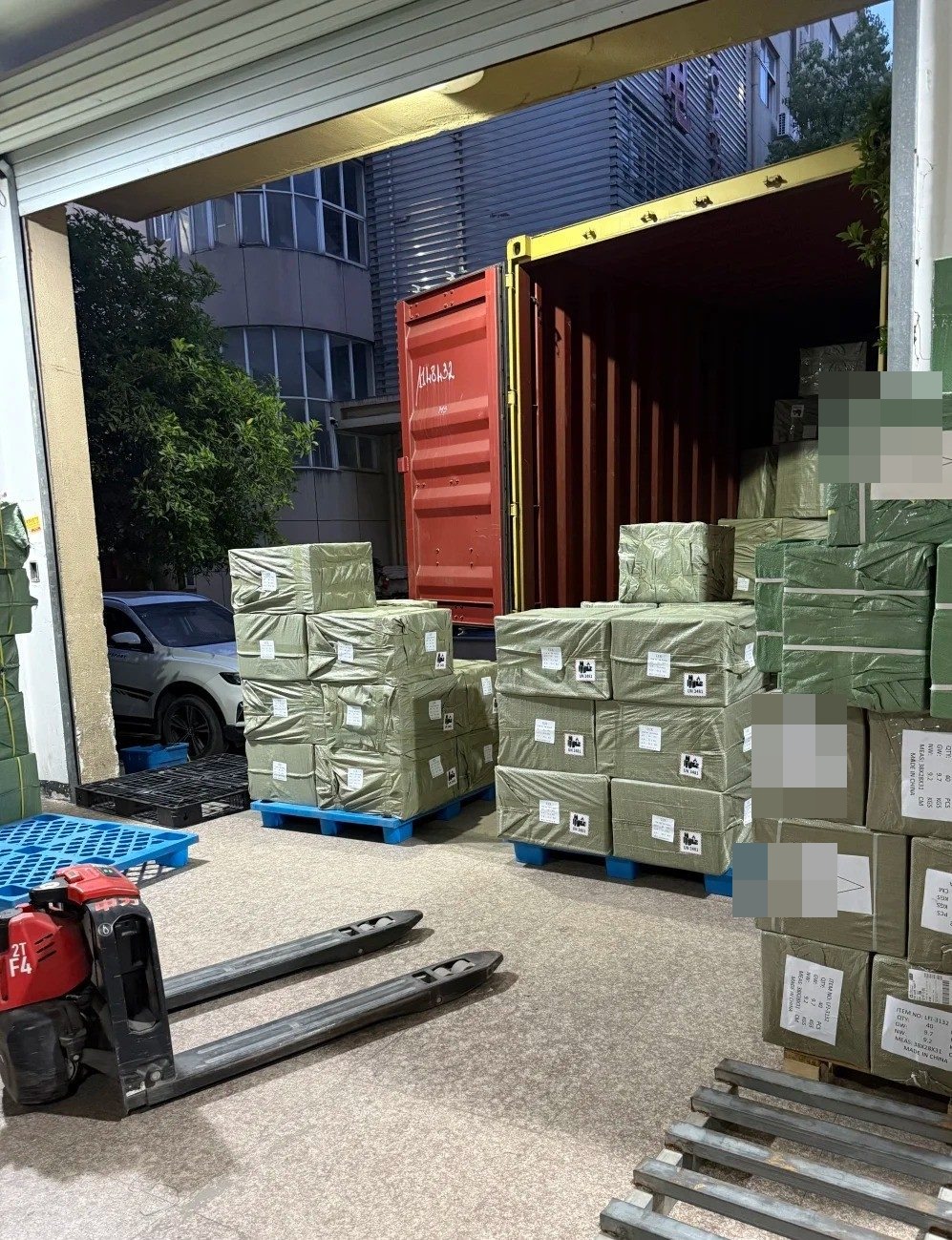 Shipping container being loaded with finished furniture