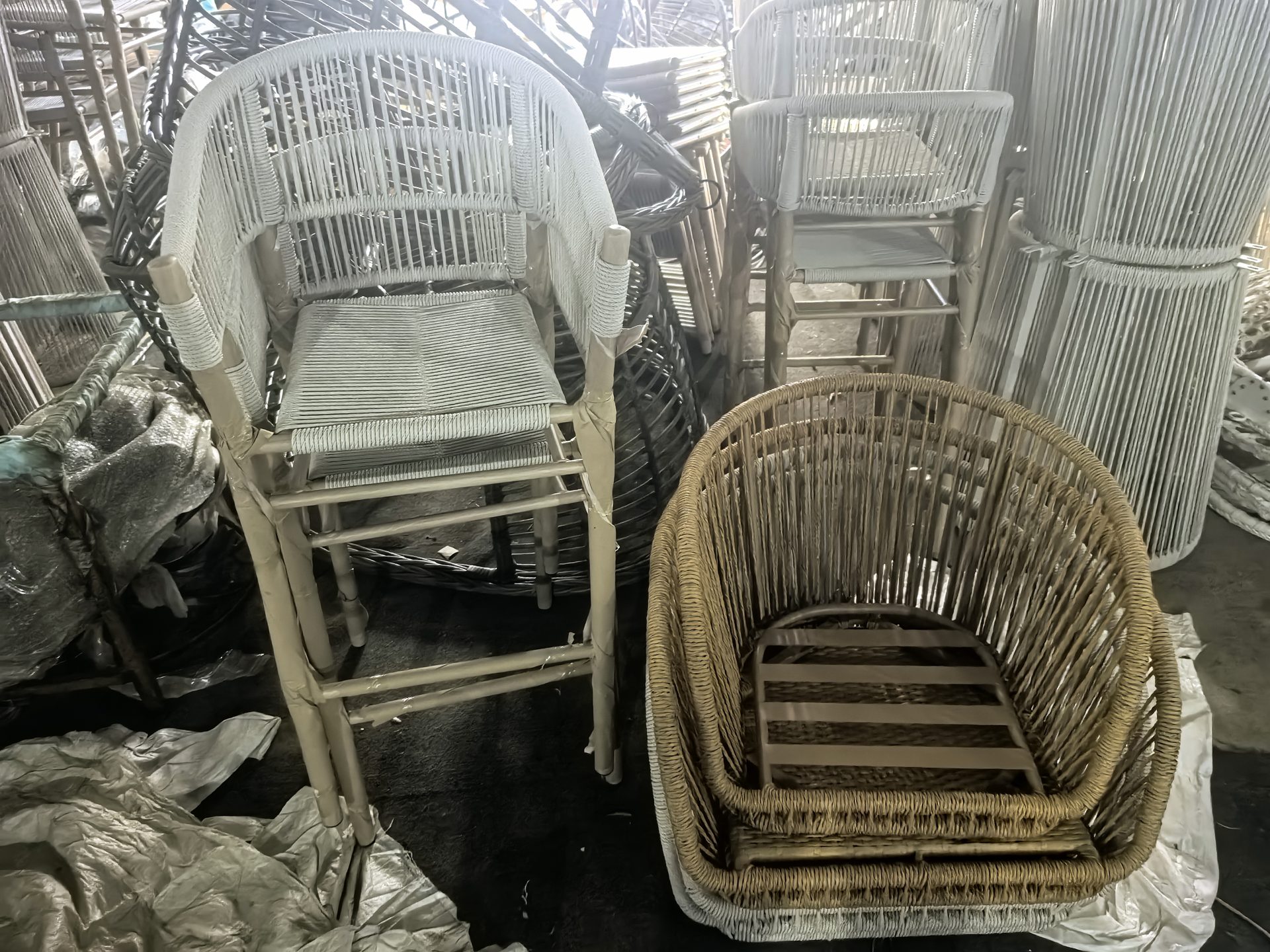 Semi-finished furniture frames lined up on a factory floor