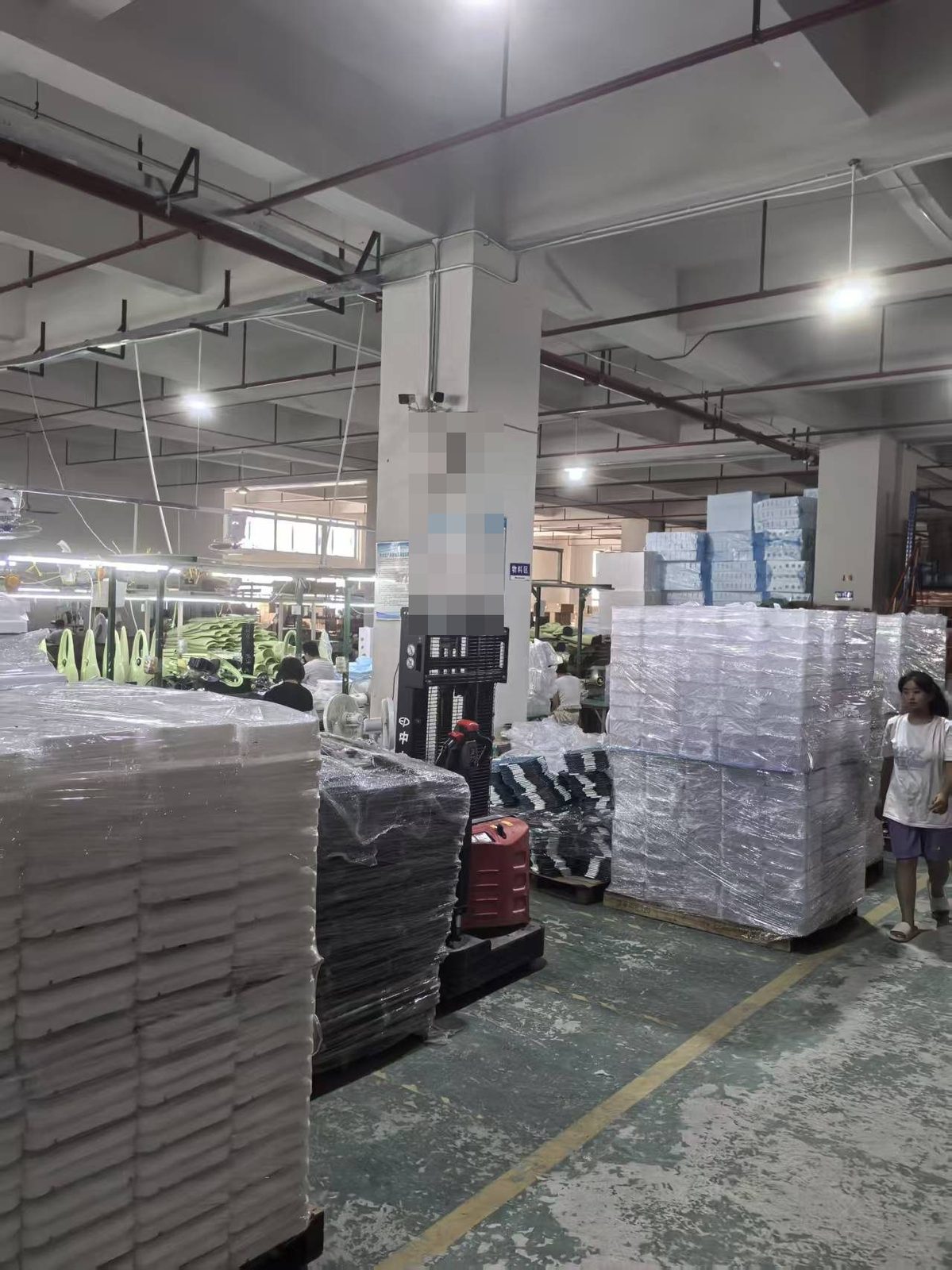 Packing area with palletised goods inside a Chinese factory